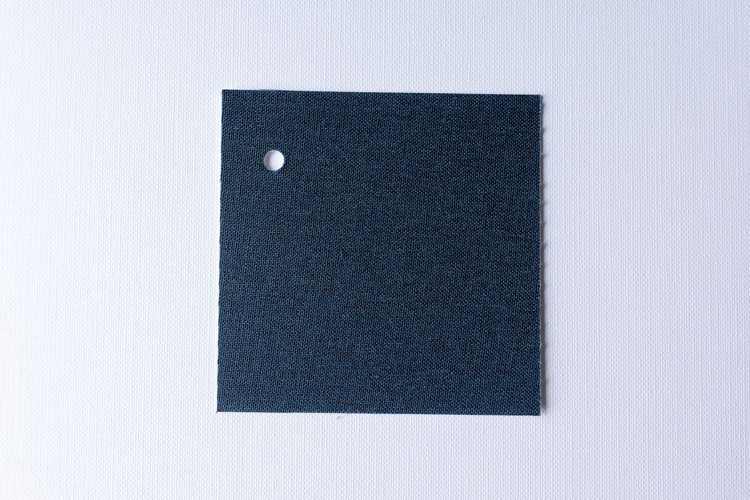 A series of five dark blue rectangular fabric swatches arranged in a horizontal row against a light background.