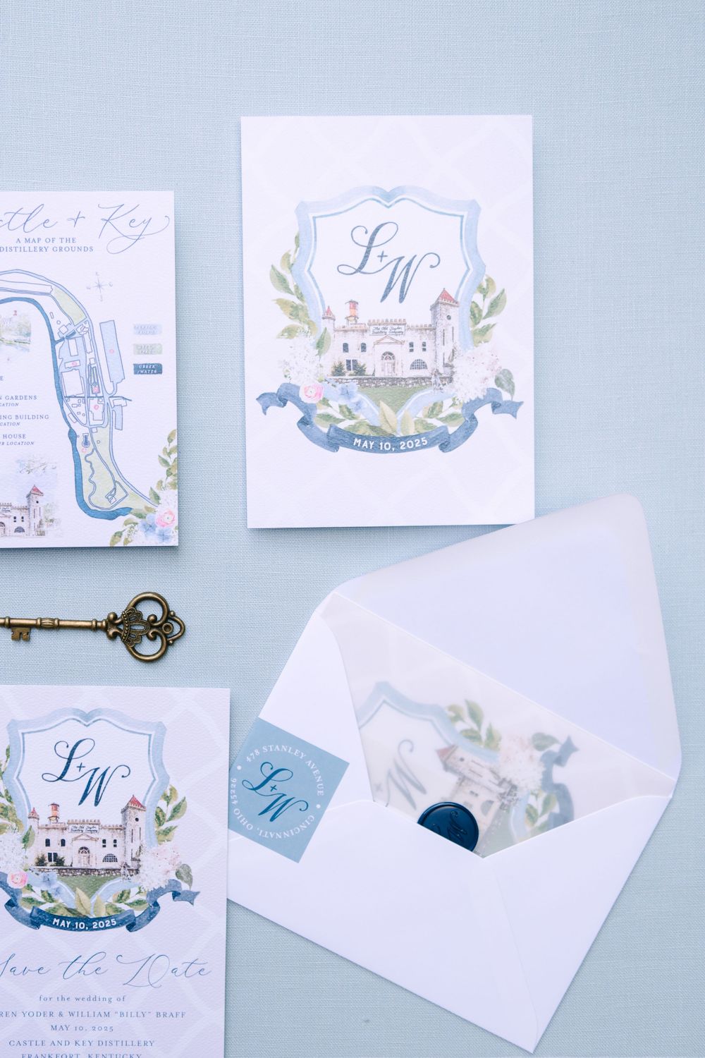 Delicate watercolor wedding stationery suite in soft blue tones featuring custom illustrations and calligraphy.