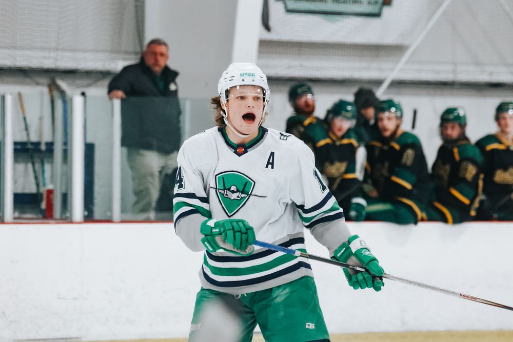 Hockey players in white and green jerseys compete for the puck during an intense game on the ice.