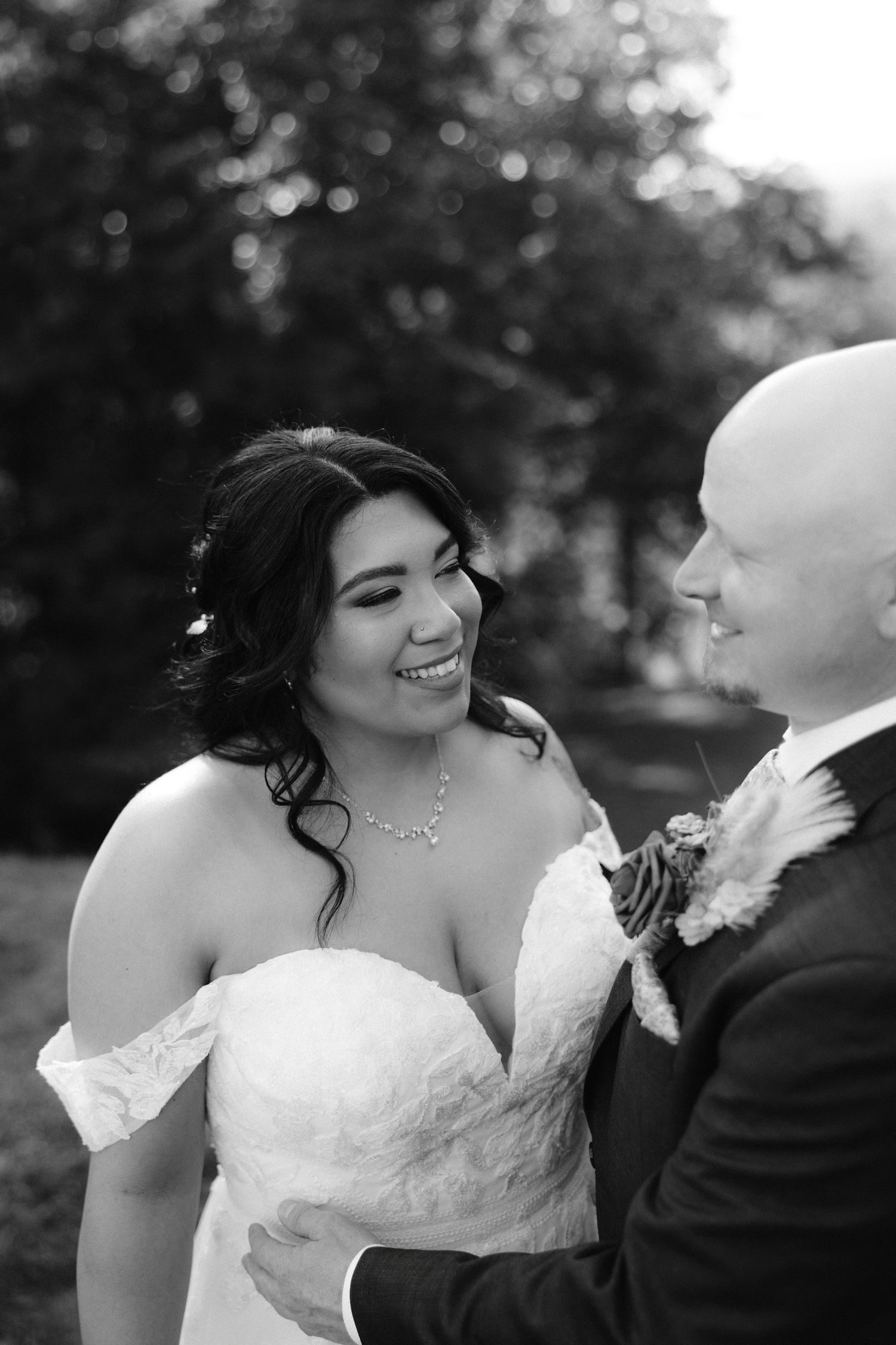 Black and white wedding photo sequence showing tender moments between newlyweds as they share joyful laughter together.