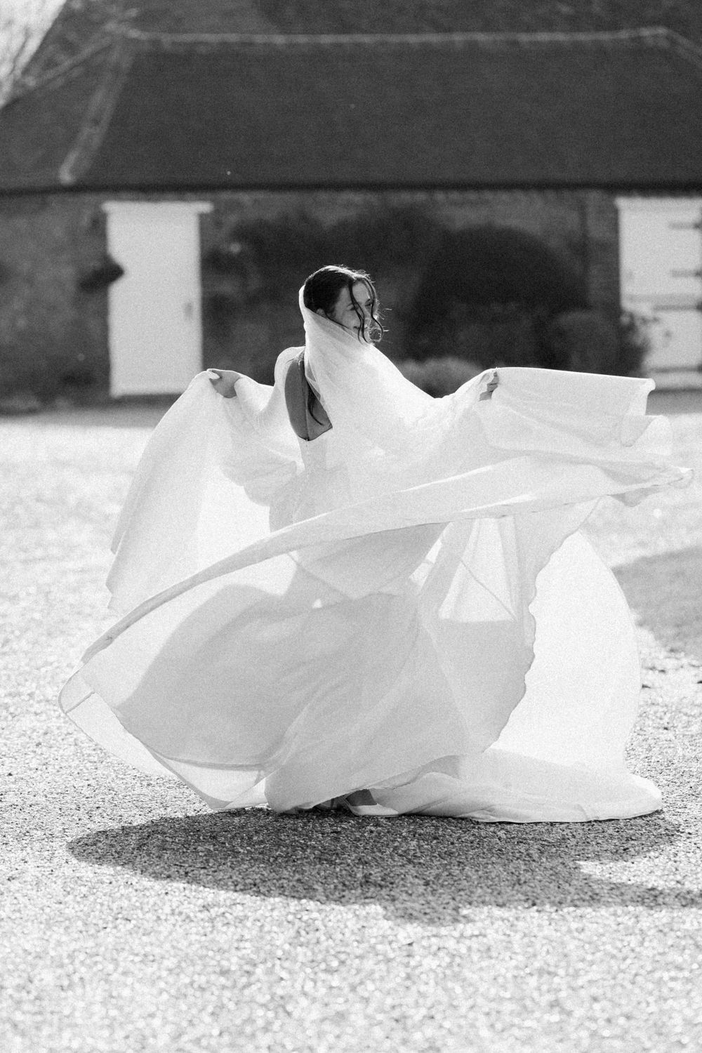 A flowing white wedding dress train drapes elegantly across a textured floor in a series of artistic black and white photos.