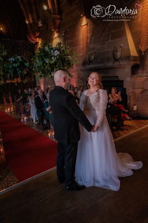 A romantic evening wedding ceremony captured in a sequence of dimly lit photos showing a couple exchanging vows.