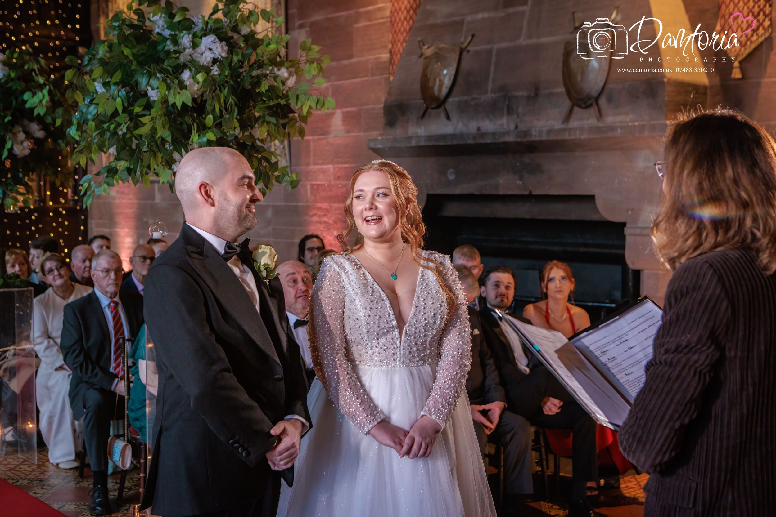A romantic first dance between newlyweds at an elegant indoor wedding reception with brick walls and soft lighting.