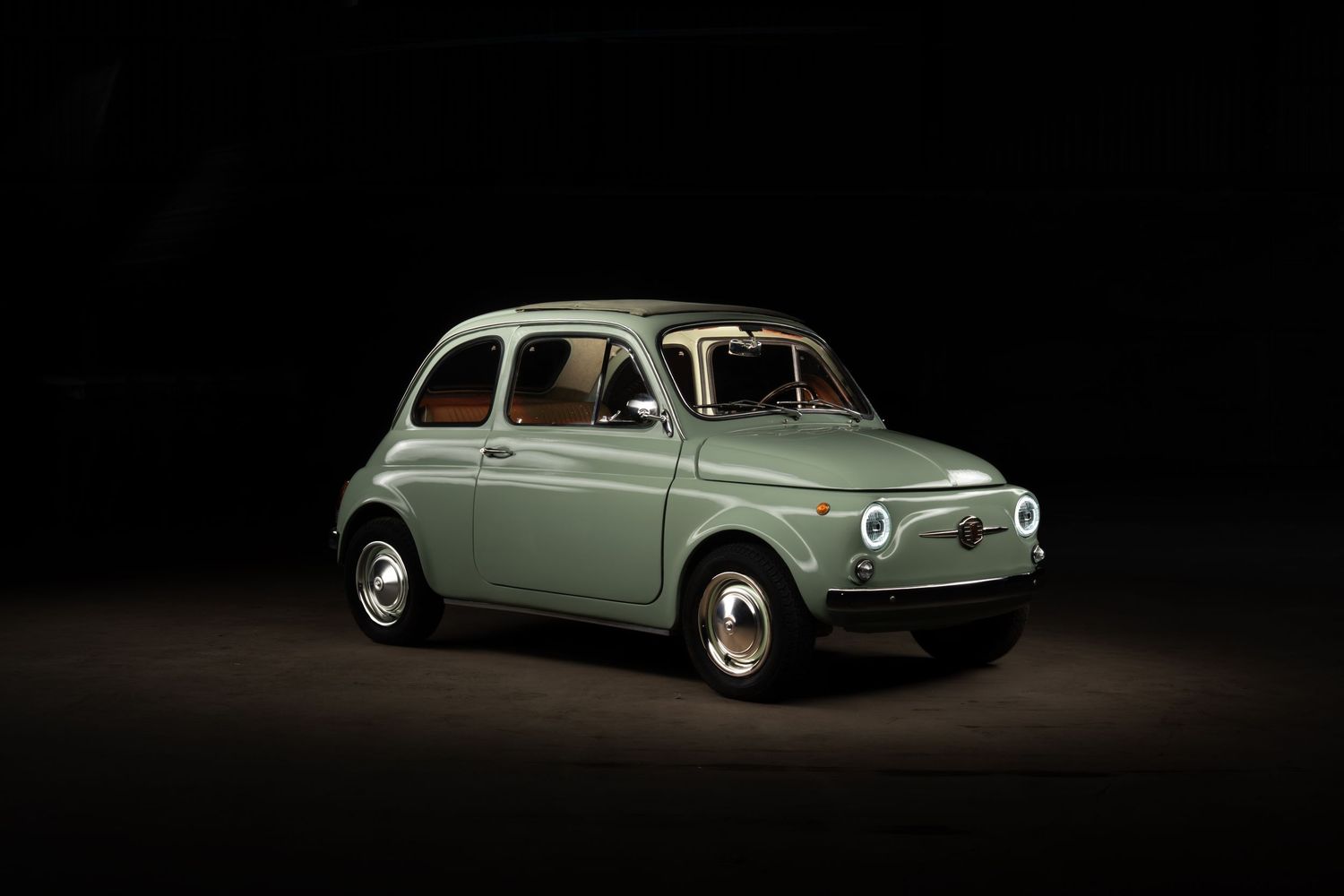 A vintage light green Renault 4CV car photographed from multiple angles against a dark background.