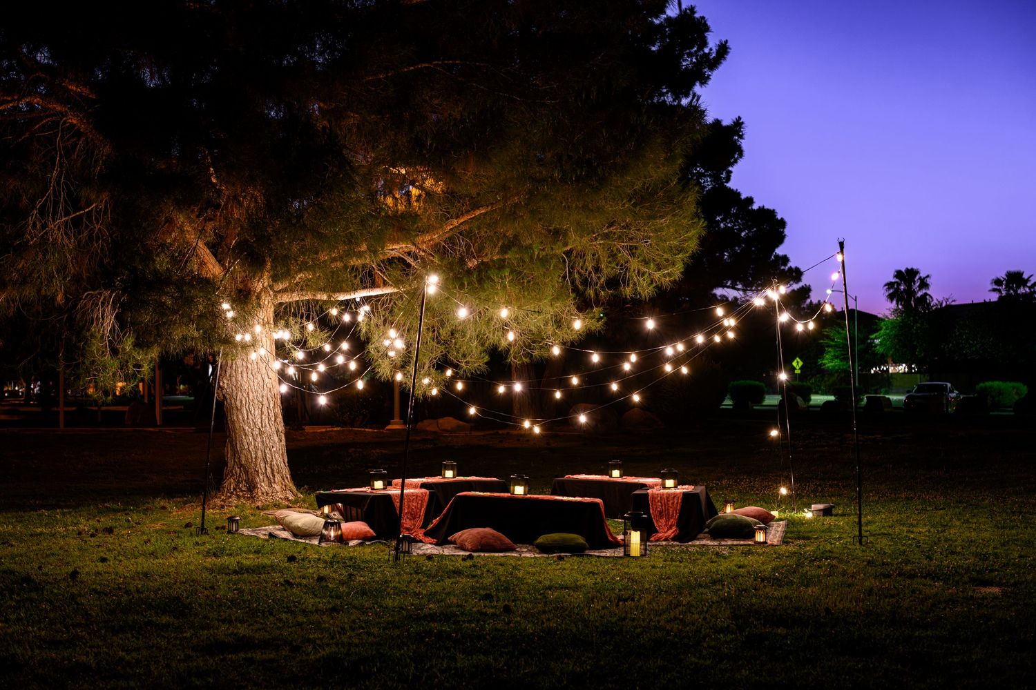 String lights illuminate an outdoor seating area at night creating a cozy ambiance in a romantic setting. Branding photography Las Vegas