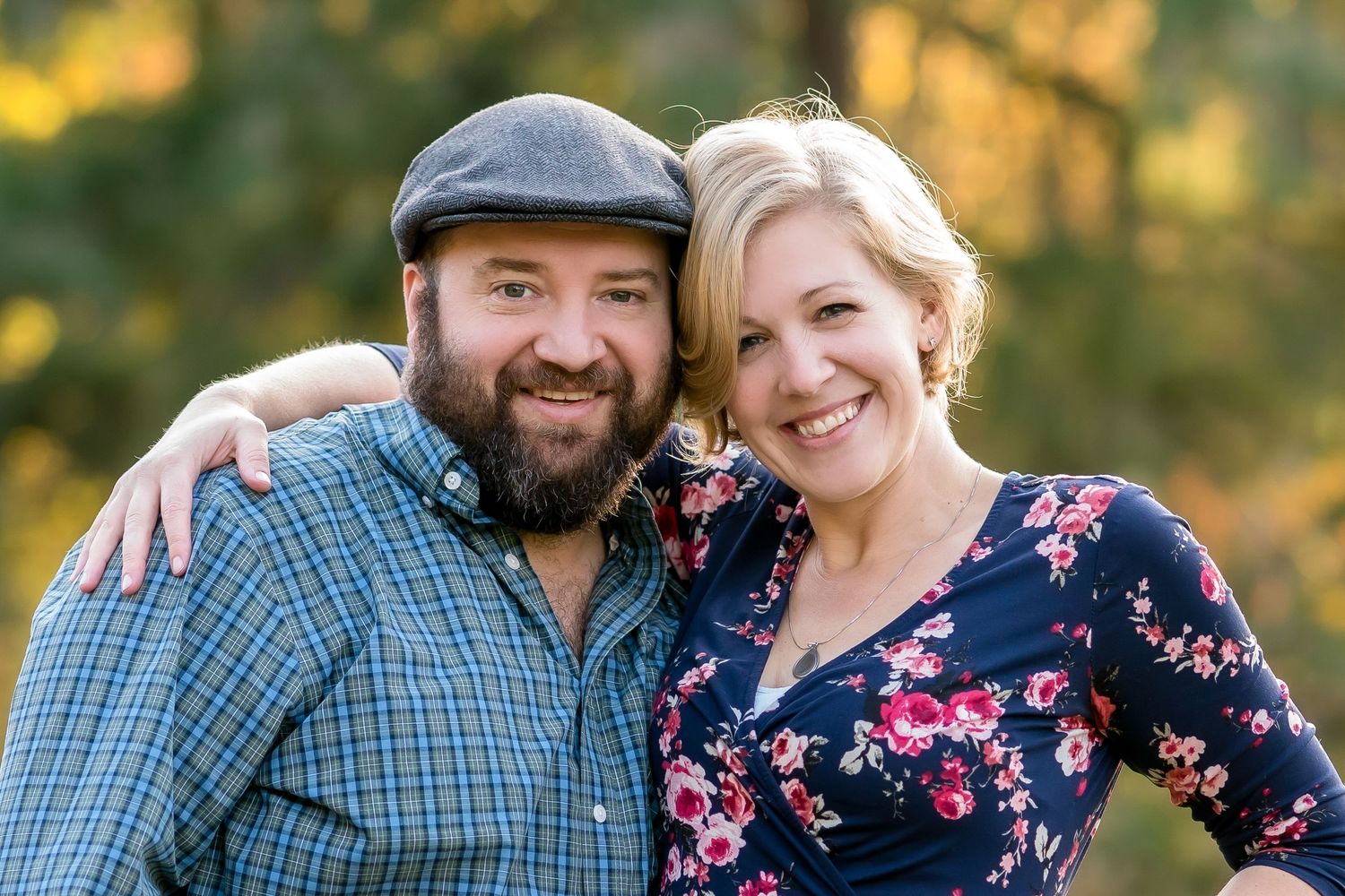 Couple in casual attire sharing affectionate moments during outdoor autumn photoshoot.