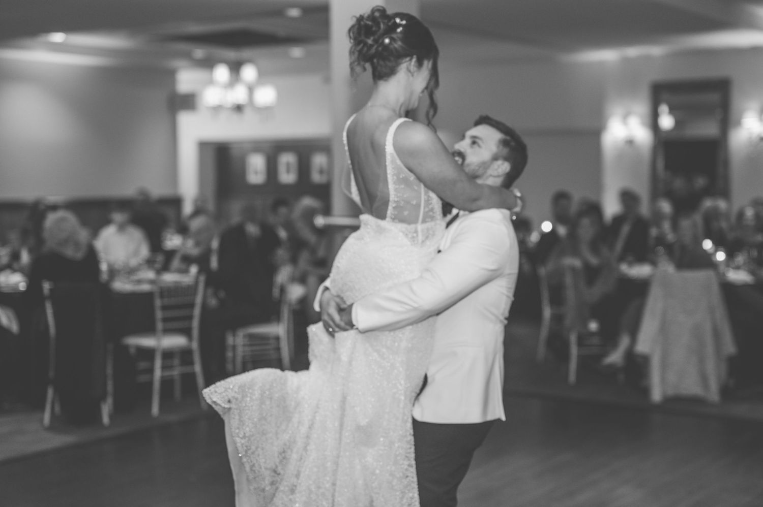 Romantic black and white photo series of a couple dancing intimately at their wedding reception.