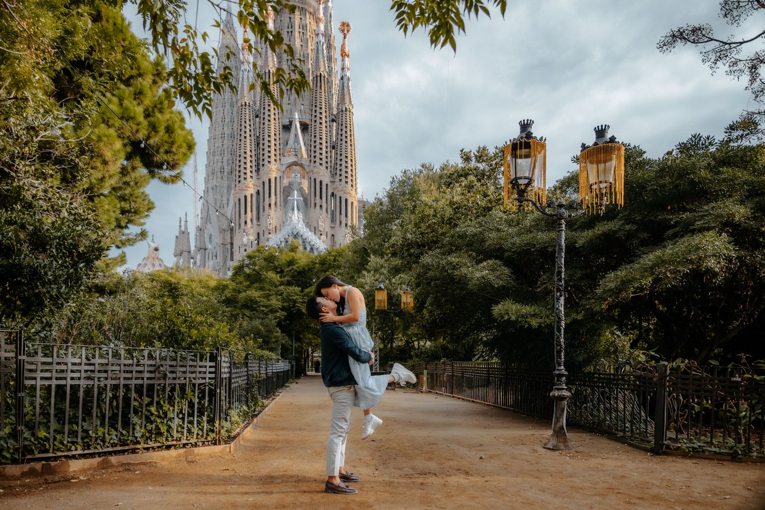 Proposal photographer capturing emotional moment at Sagrada Familia gardens