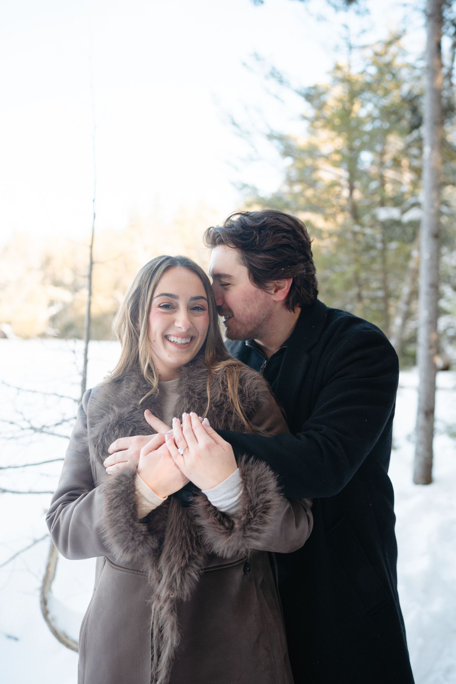 A romantic winter photo sequence shows a couple sharing playful moments in a snowy forest setting.