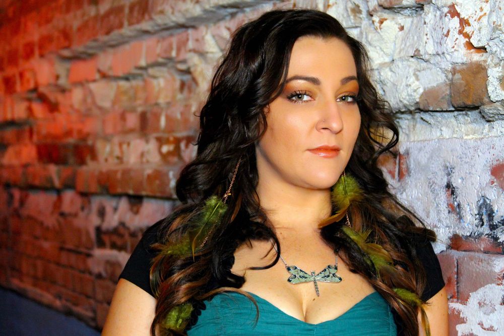 Portrait series against a rustic brick wall with dramatic lighting.