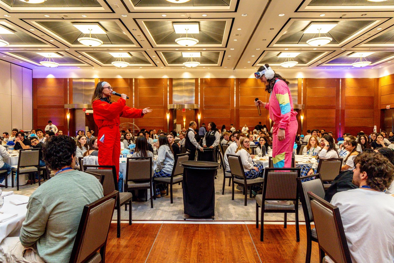 A panoramic view of a large banquet hall with elegant lighting and tables set up for a formal event.