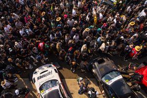 Aerial view of a large crowd gathering at a public event with people densely packed together.