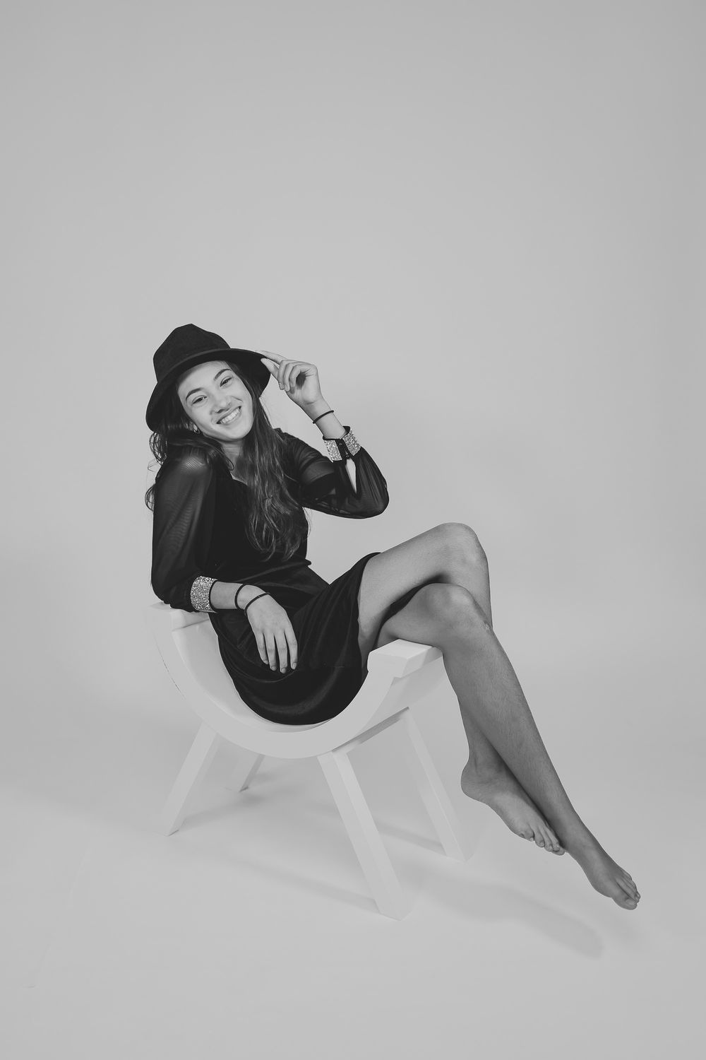 Artistic black and white photo series of relaxed poses on light background.