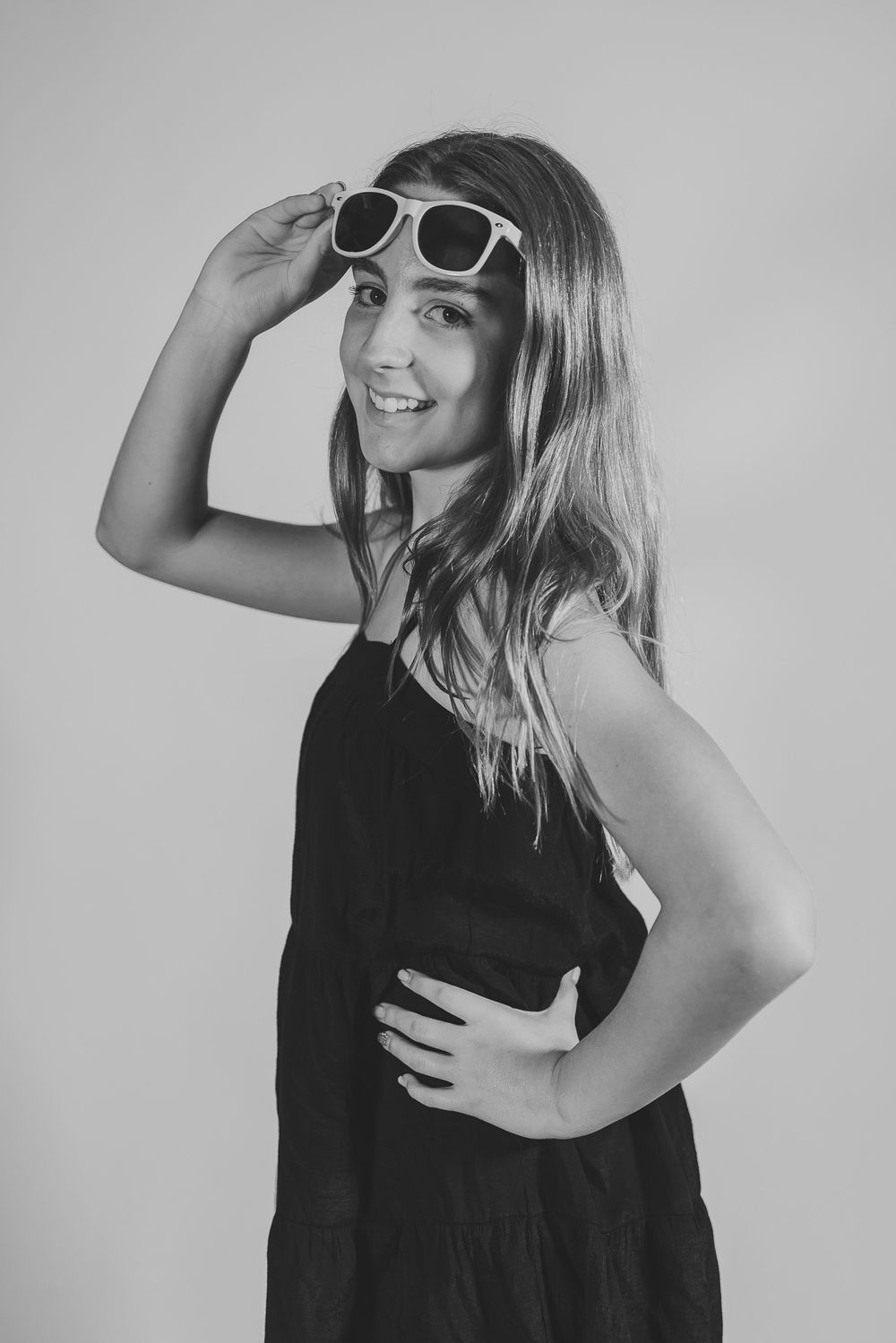 Stylish black and white fashion portraits featuring sunglasses and casual poses.