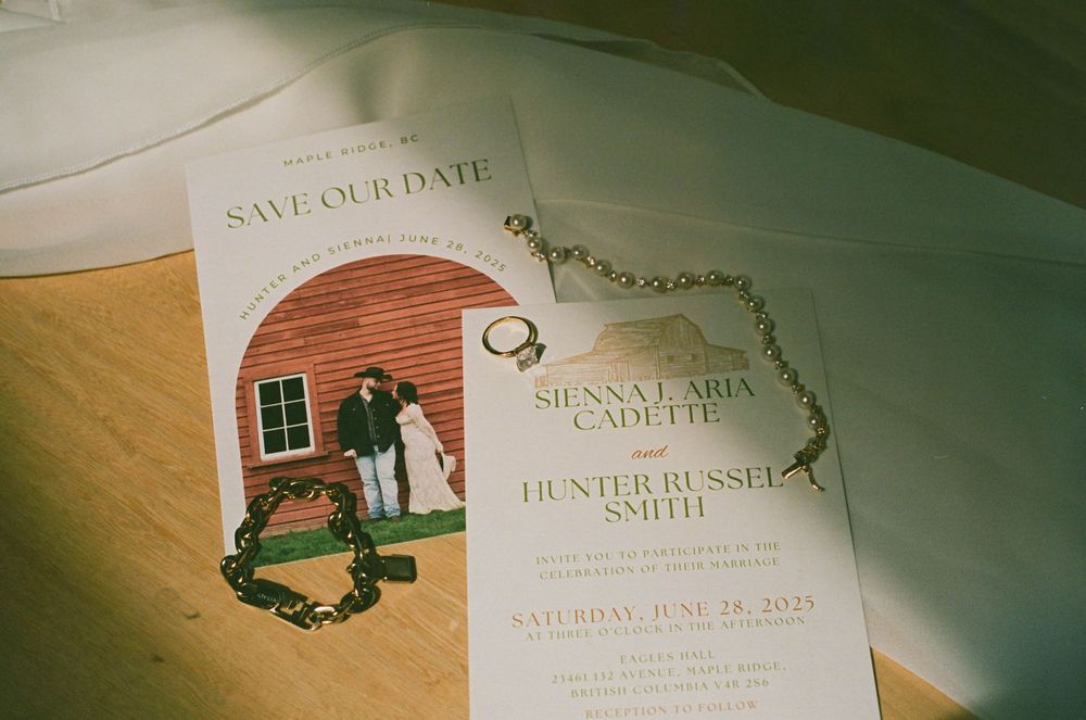 Wedding save-the-date cards and invitations laid out showing event details.