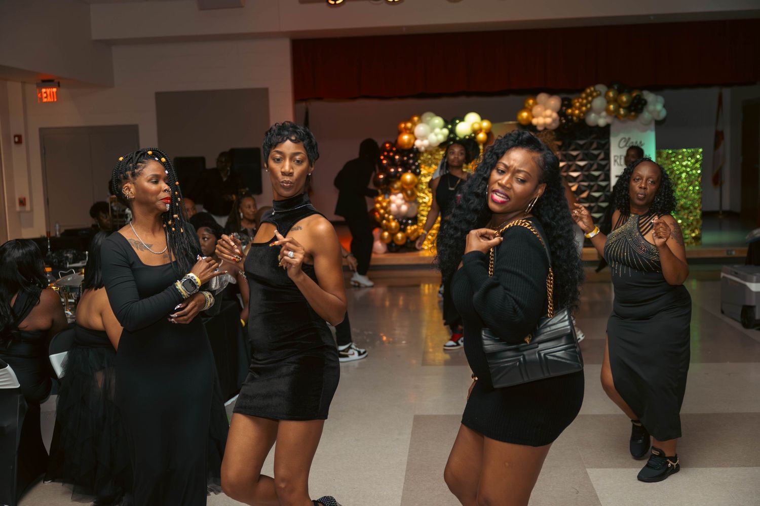 Women dancing and celebrating on the dance floor at a class reunion party.
