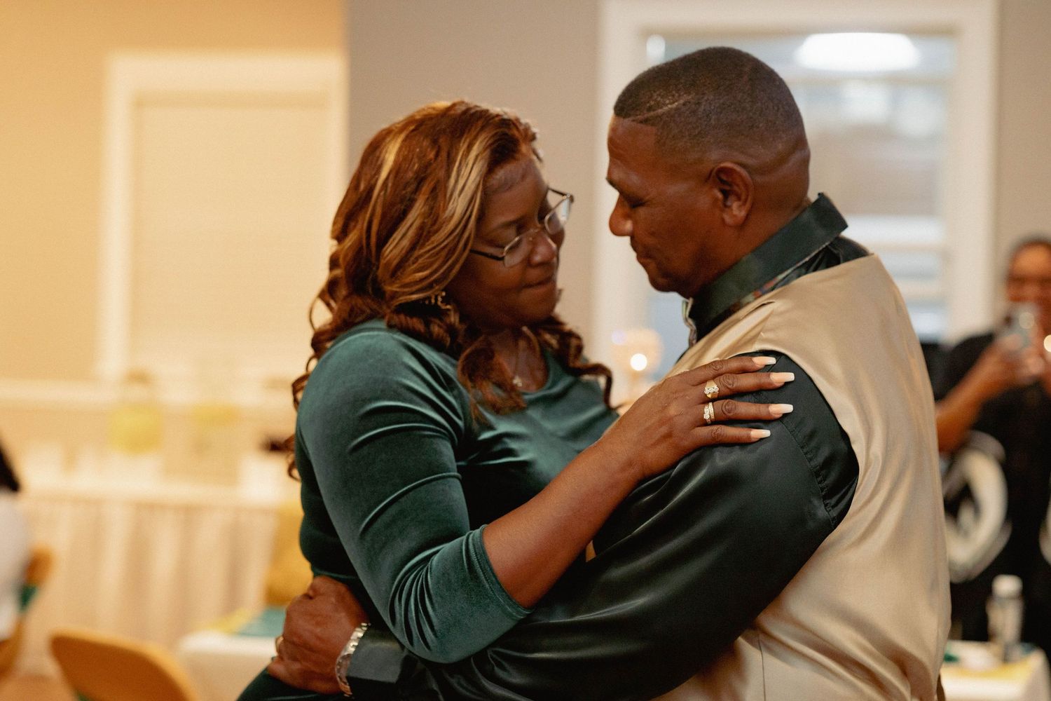Couple sharing an embrace on the dance floor at a celebration.