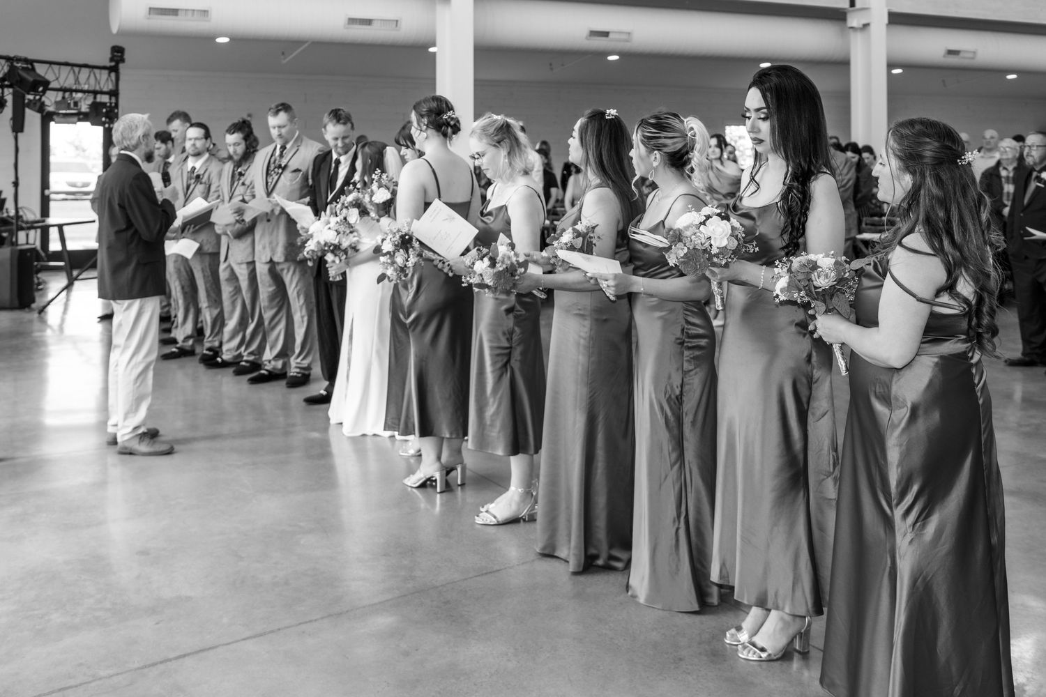 A series of black and white images showing a person preparing and adjusting a wedding dress for a special occasion.