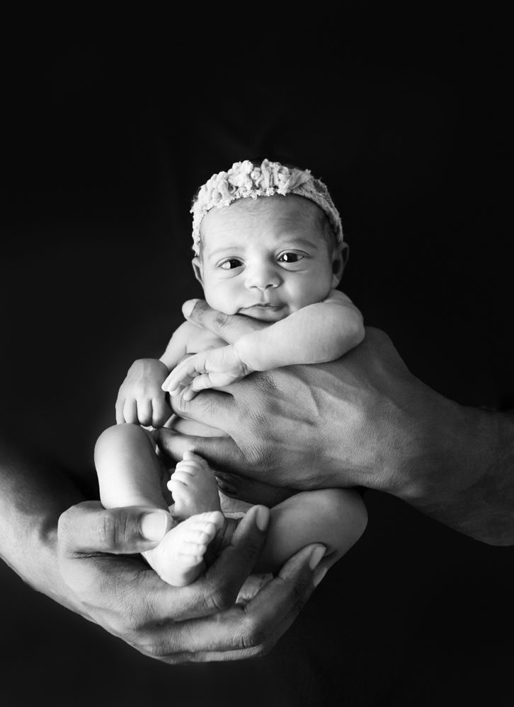 Black and white photo of a newborn baby cradled in gentle hands, Orlando Newborn Photographer, Orlando Newborn Photography, Sanford Newborn