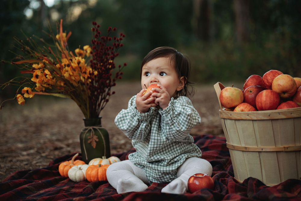 Autumn scene with pumpkins, baskets and fall foliage decorations.