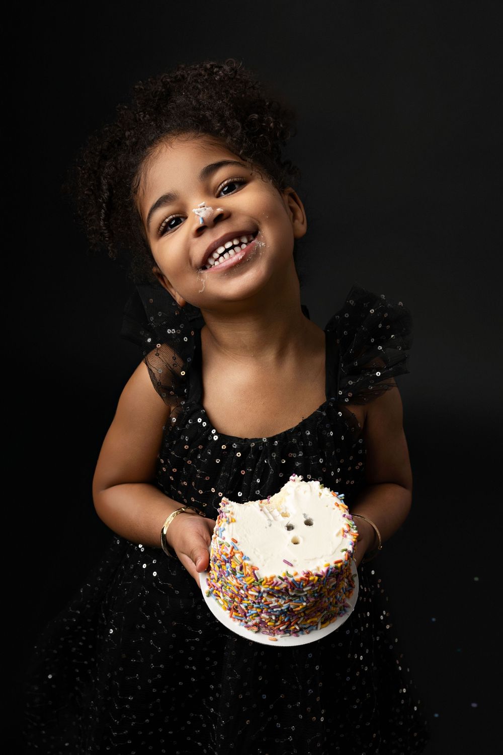A joyful moment captured in a series of photos showing someone in a sparkly black dress enjoying cake with sprinkles.