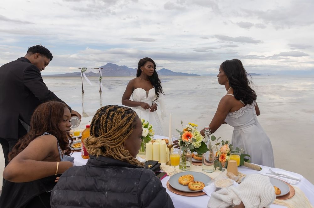 couple standing amid salt flats in a wedding attire ready for their first dance