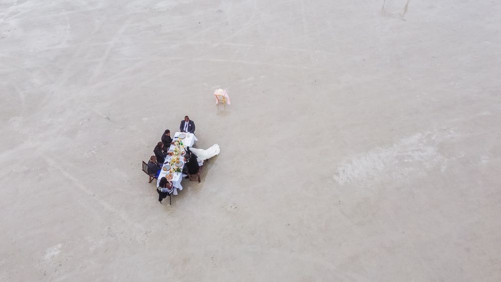 couple standing amid salt flats in a wedding attire ready for their first dance