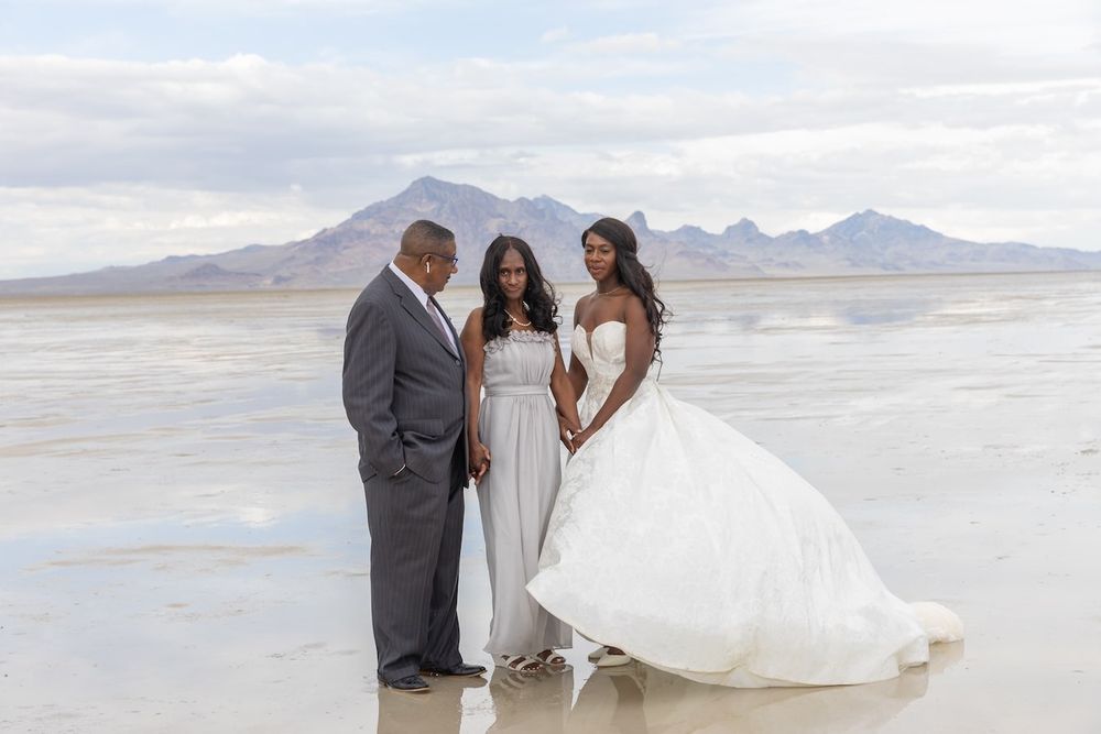 couple standing amid salt flats in a wedding attire ready for their first dance