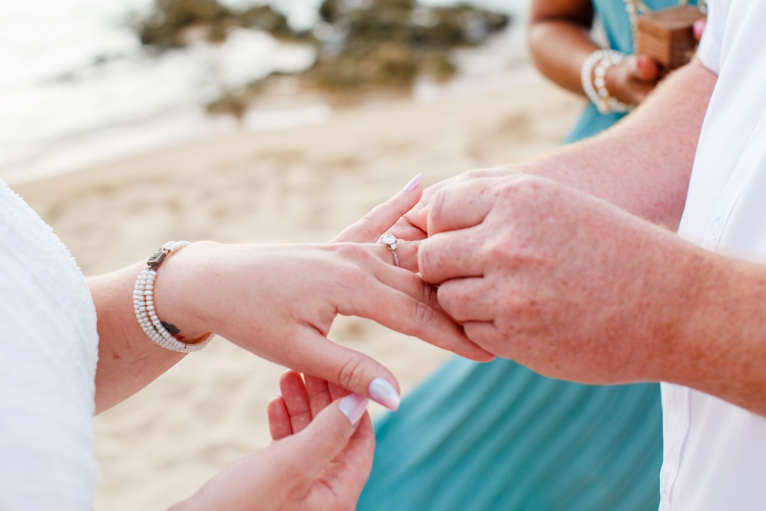 Elopement on the beach at Balneario del Escambrón in Old San Juan, Puerto Rico. Wedding ceremony. Bride and groom. Wedding ring.