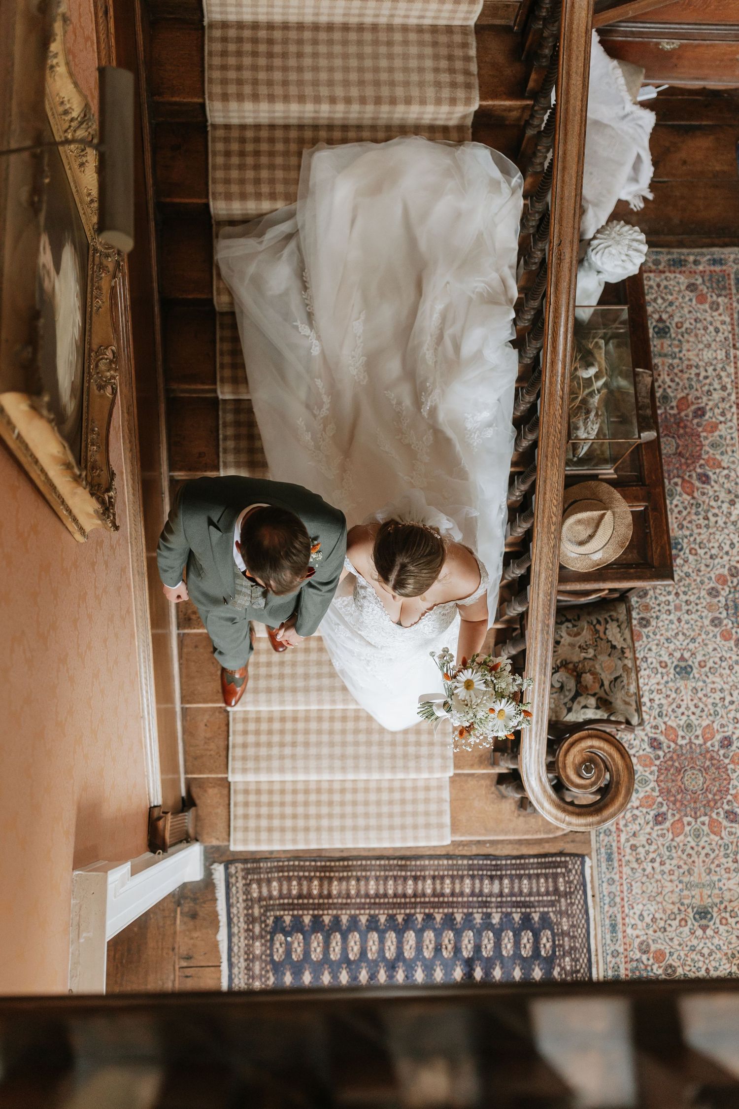 Elegant wedding dress and vintage furniture details in rustic setting with gingham pattern accents and decorative tiles.