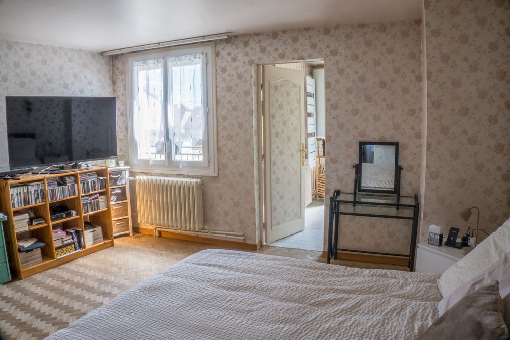 Four interior photos showing an empty apartment or home with white walls, wooden floors, and wallpapered accent walls.