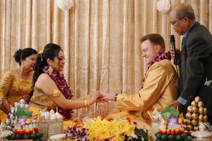 Elegant wedding reception banquet table decorated with golden candelabras and floral centerpieces at an upscale venue.