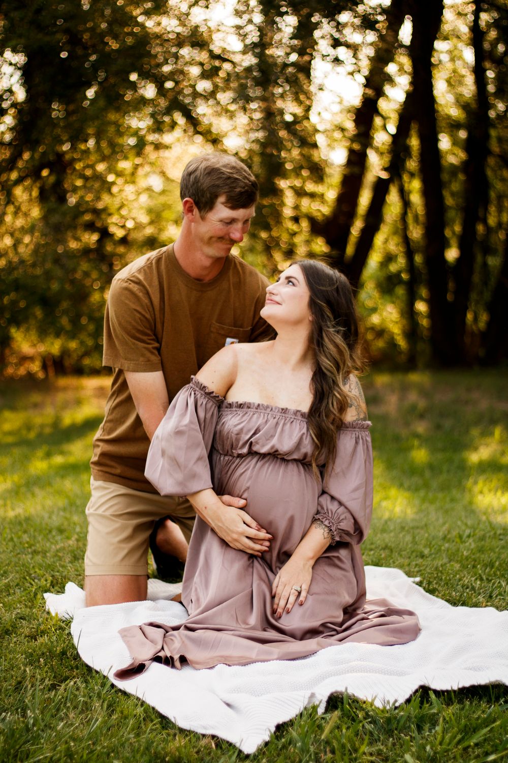 An expecting couple during a maternity photo session at The League House in Amarillo, Texas