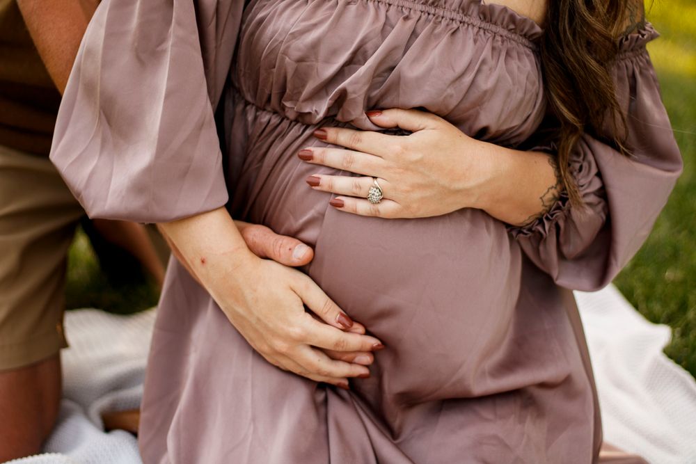 An expecting couple during a maternity photo session at The League House in Amarillo, Texas