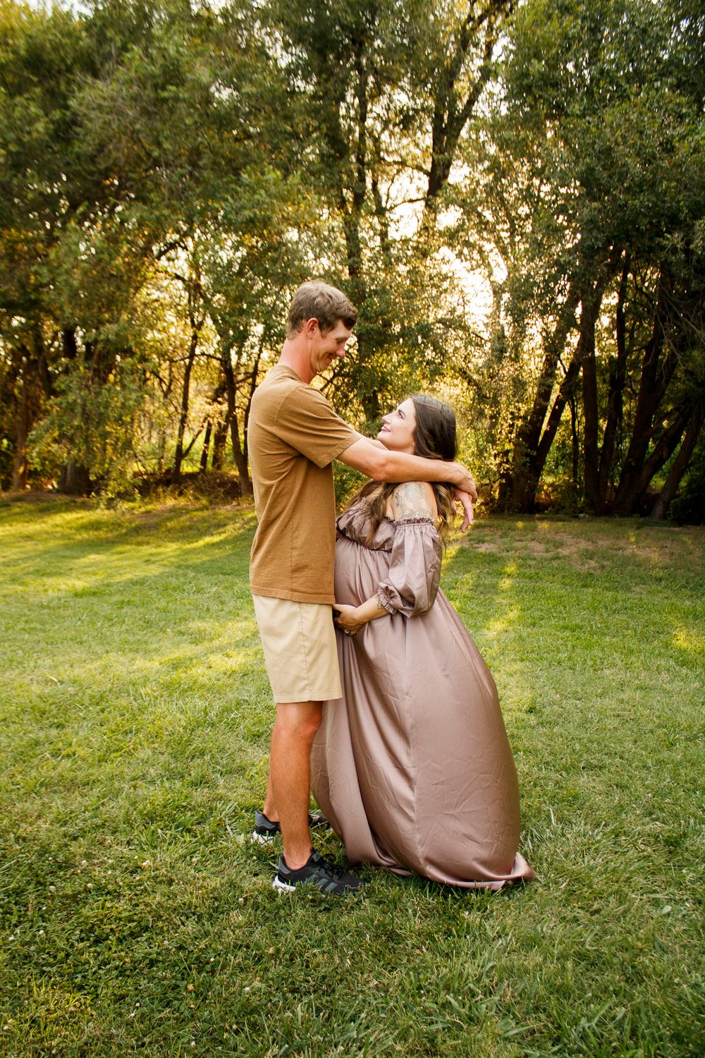 An expecting couple during a maternity photo session at The League House in Amarillo, Texas