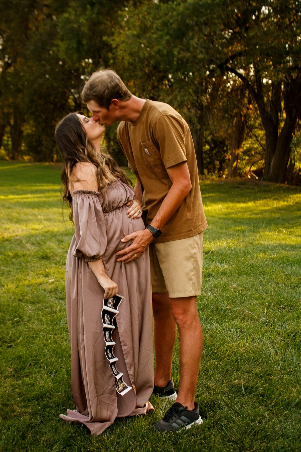 An expecting couple during a maternity photo session at The League House in Amarillo, Texas
