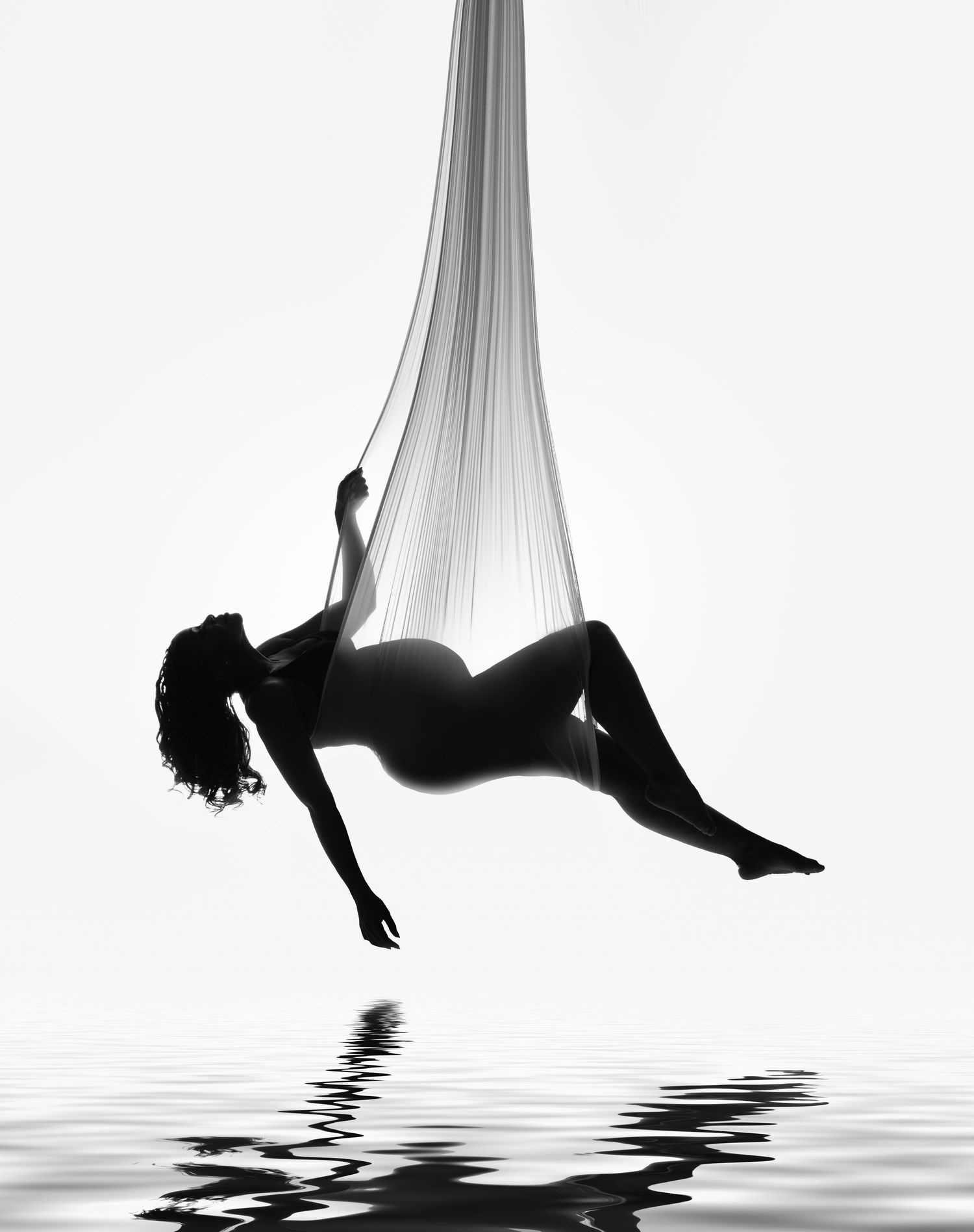 A dramatic black and white triptych shows a silhouetted figure floating and twisting above a reflective water surface.