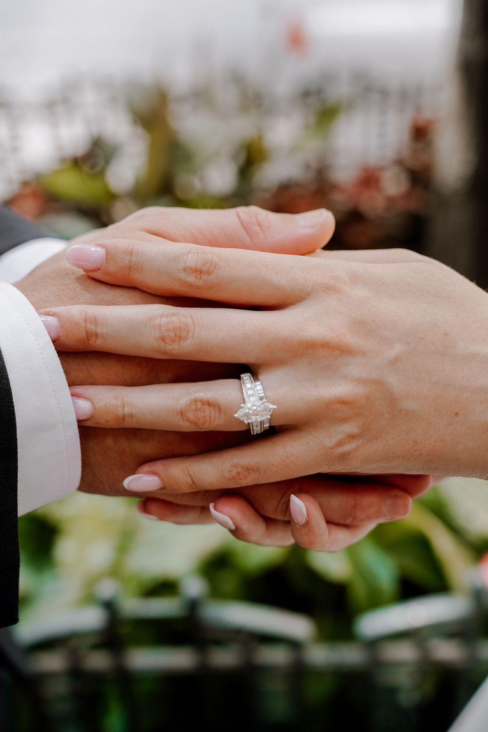 Close up shots of hands showing off an engagement ring in a sequence.