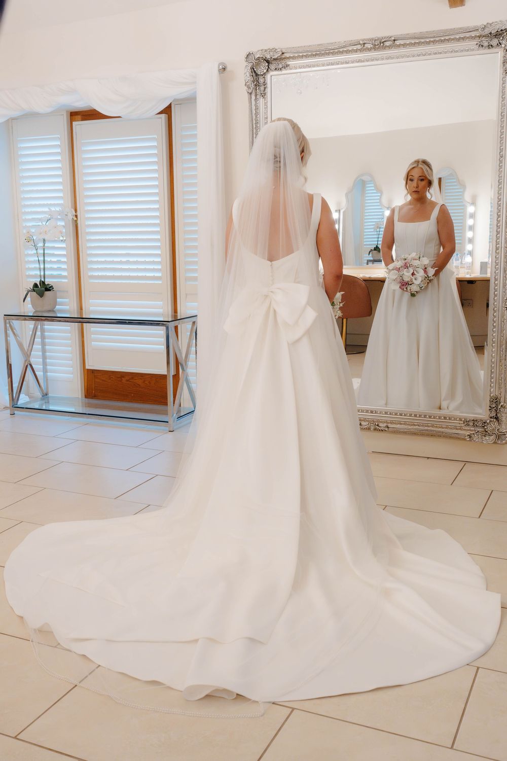 Kingscote Barn Wedding Photographer Zara Davis Photography Cotswolds Gloucestershire Cheltenham bride portrait in mirror bridal suite