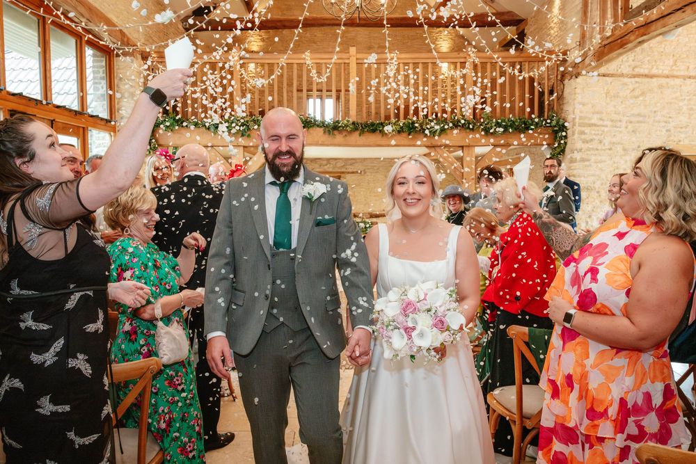 Kingscote Barn Wedding Photographer Zara Davis Photography Cotswolds Gloucestershire Cheltenham confetti exit indoors