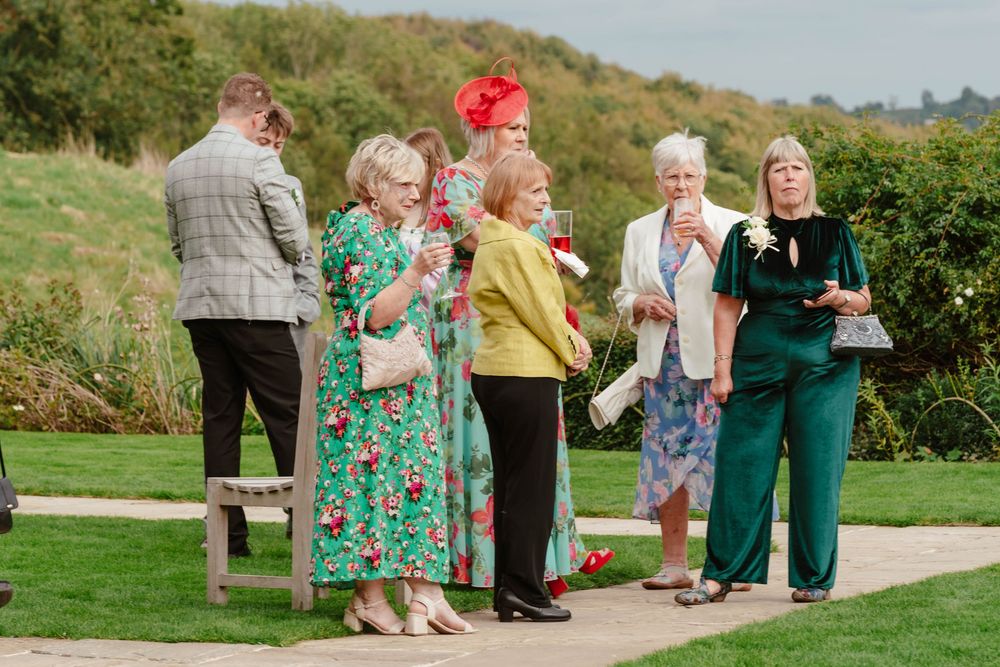 Kingscote Barn Wedding Photographer Zara Davis Photography Cotswolds Gloucestershire Cheltenham guests during drinks reception on lawn