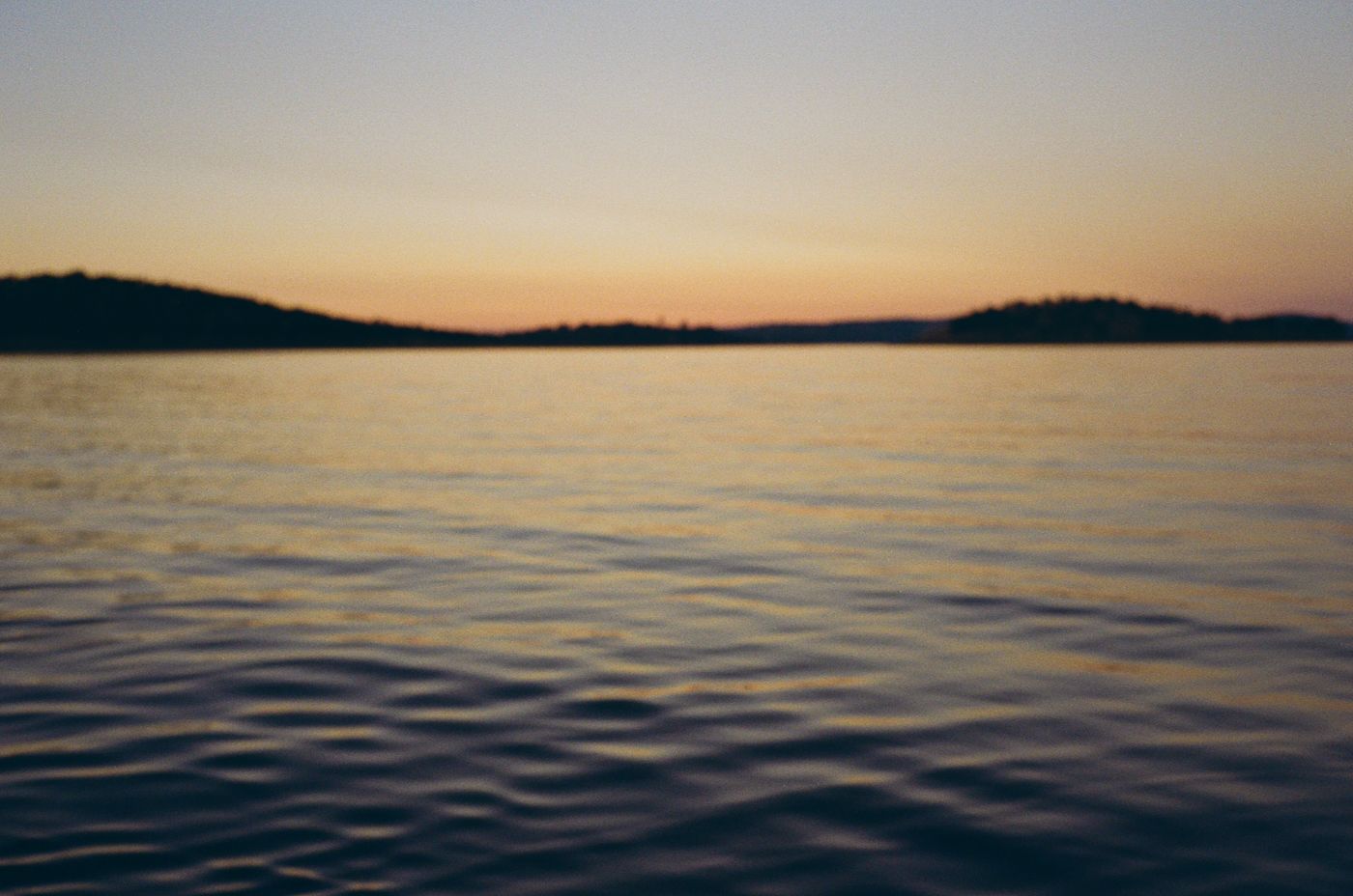 A series of peaceful ocean sunset scenes with rippling water and golden light reflecting on the calm surface.