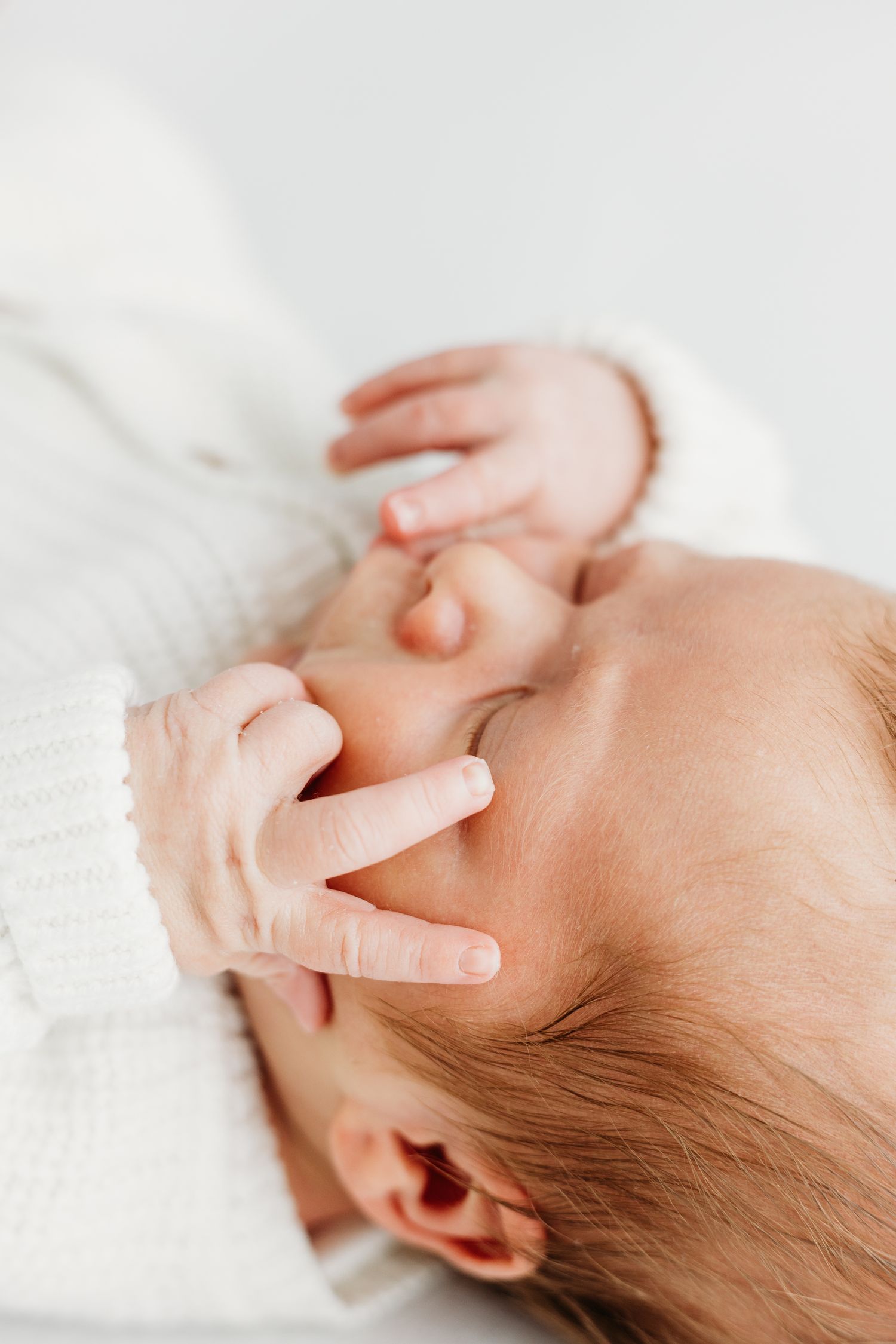 Baby’s first portraits in Nottingham studio, captured in neutral tones by Mapperley newborn photographer.
