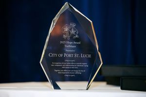 Crystal award trophy displaying City of Port St. Lucie text against dark blue background.