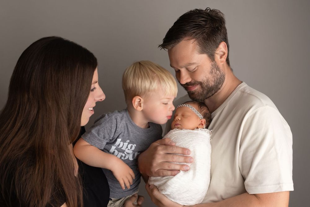 Baby girl with family, taken by Jen Knightstep, Photographer