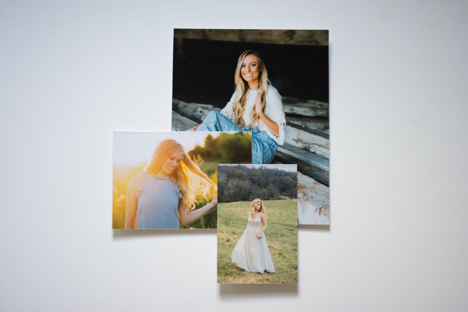 Professional portrait prints arranged in a row showing outdoor photography.