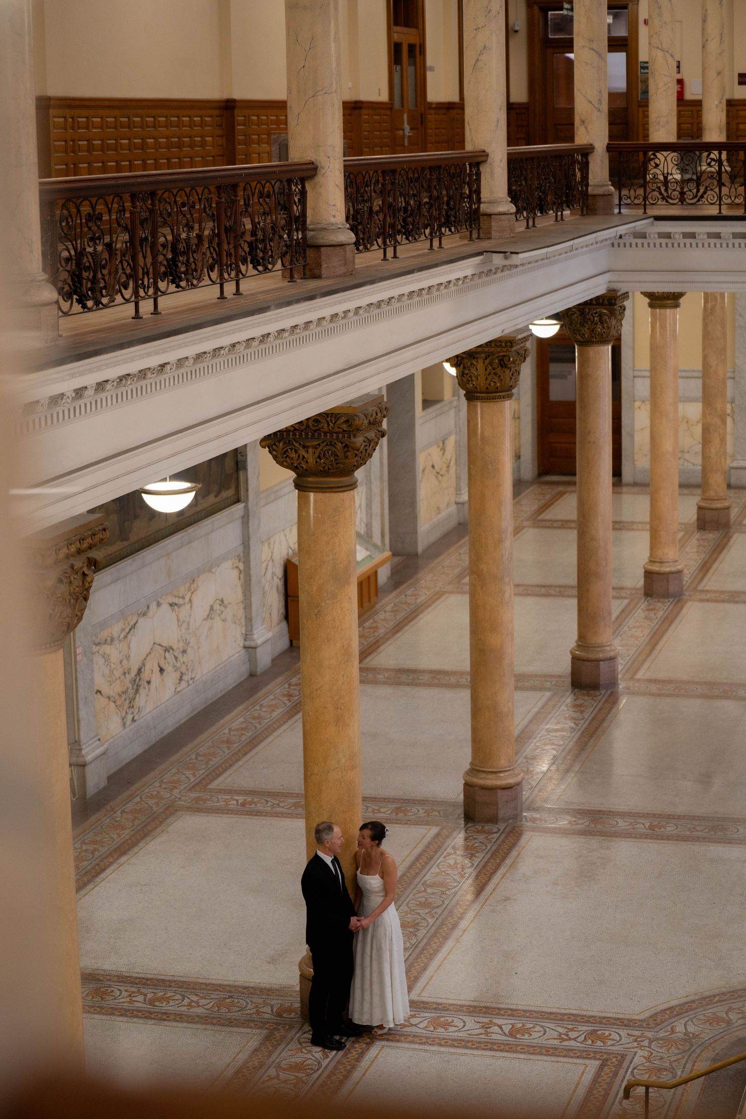 Wedding celebration panorama showing reception details with floral arrangements.