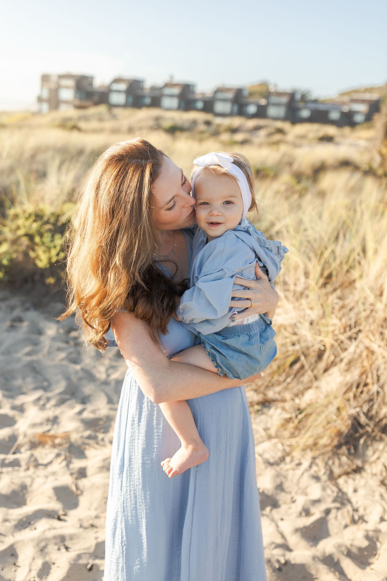 A tender moment captured in a series of photos at the beach showing affection and connection against a sandy backdrop.Film by Chelsee Rawe P