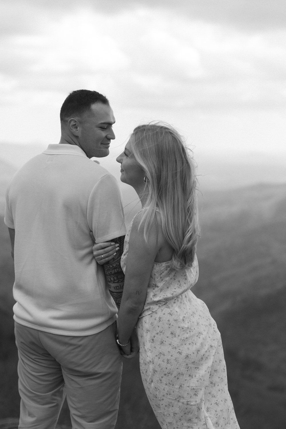 Couple holding hands while hiking to their elopement ceremony spot