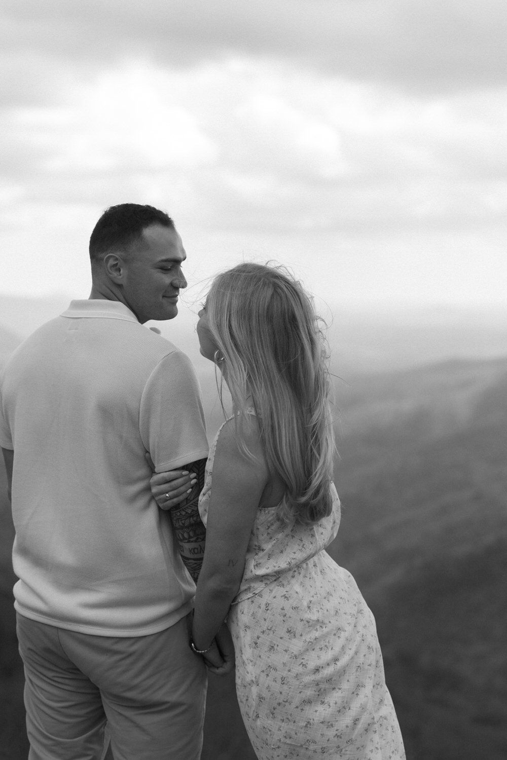 Romantic candid moment with cloudy mountain backdrop in Georgia